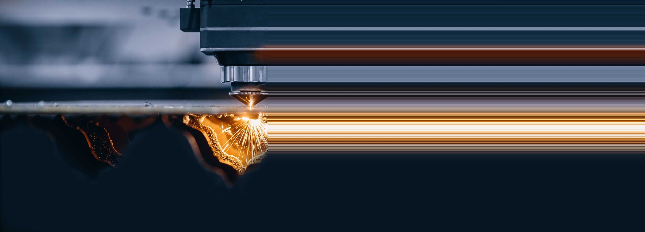 Stretched photo of a CNC laser machine, representing legacy technology; one of many modern manufacturing challenges